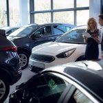 Man and woman in a car showroom